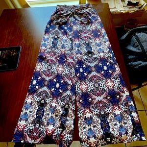 Red, white, and blue pattern silky pants with tie around and elastic waist band.